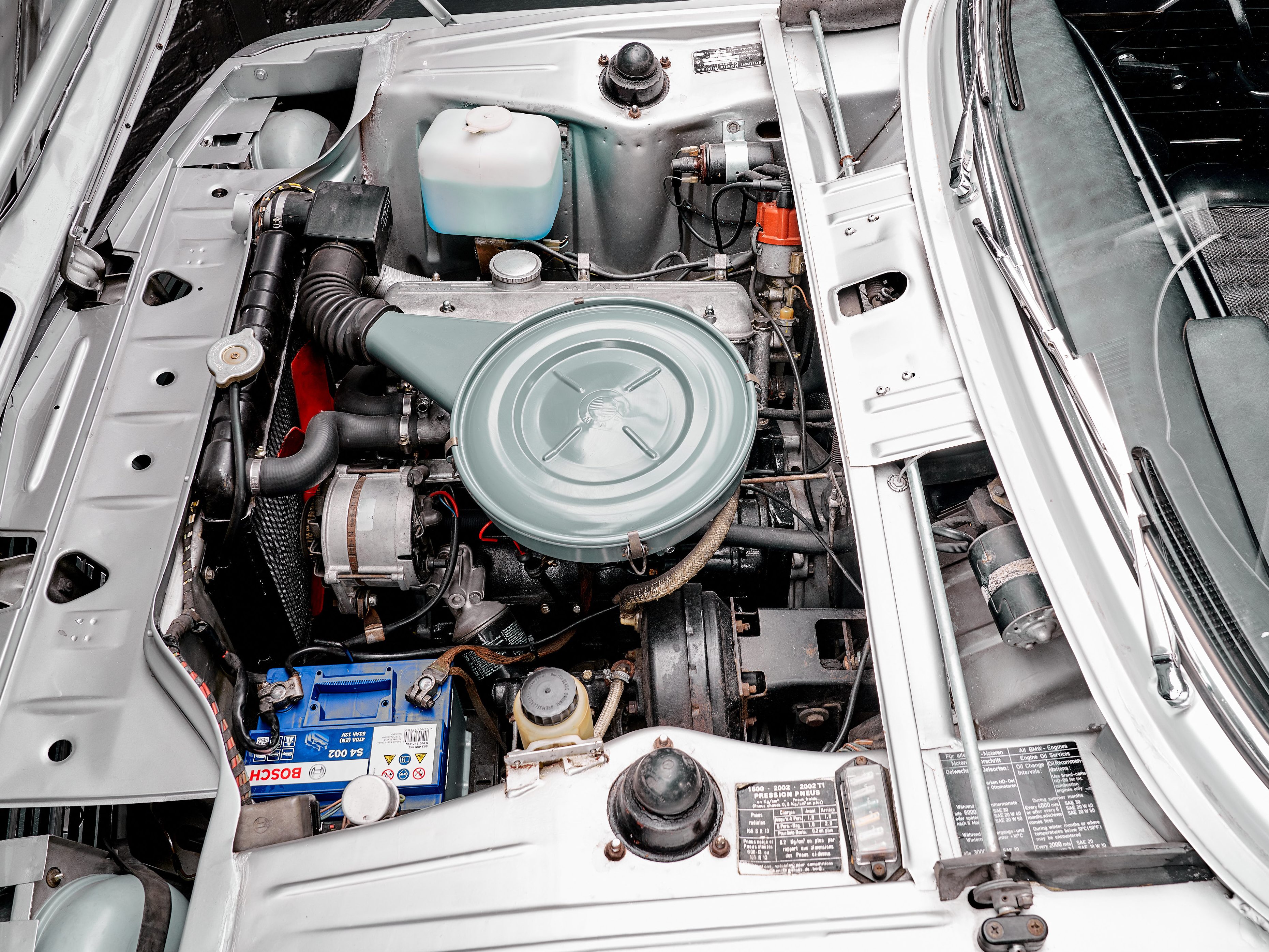 photo of the engine of a 1970 grey BMW 1602 convertible for sale by Classic 42 a classic german car dealer based in Brussels www.classic42.be