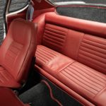 sièges arrières d'une Volvo 1800S de 1965 blanc cassé intérieur rouge en vente chez Classic 42